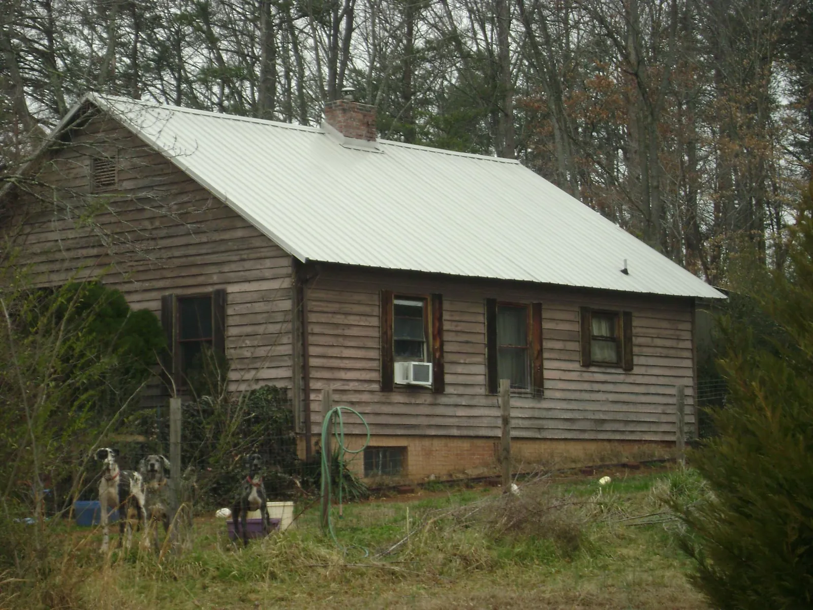 White metal roof on an old wood sided farmhouse, from a Metal Roof Installation job in Tyrone